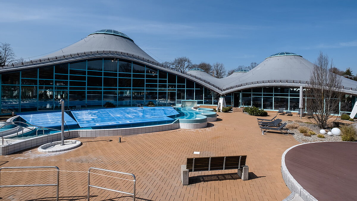 Außenbereich der Soletherme Solemar in Bad Dürrheim mit geschwungenem Glasdach und Schwimmbecken.