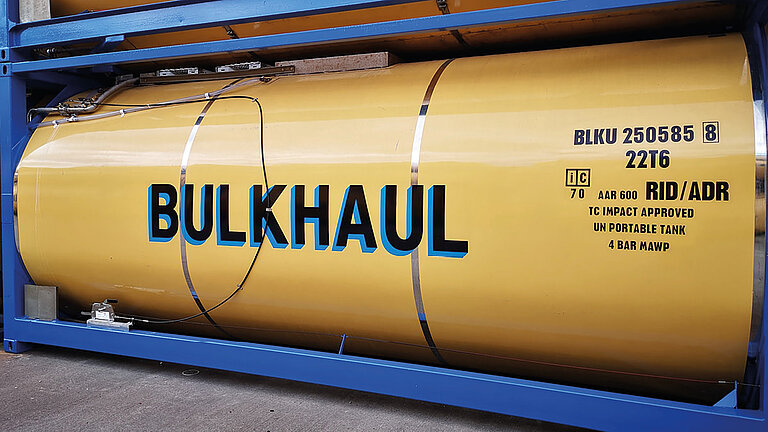 Yellow ISO tank container labeled "BULKHAUL" with GRP tank cladding